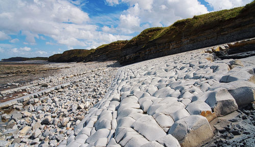 Rocks on beach against sky