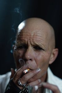 Portrait of man smoking cigarette