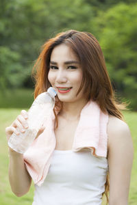 Woman sitting on field at park