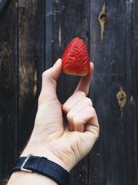 Close-up of hand holding strawberry