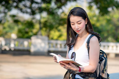 Young woman using mobile phone outdoors