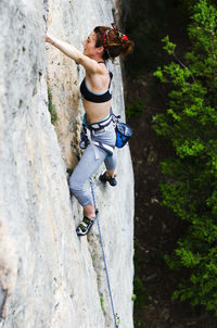 Full length of woman standing on tree trunk