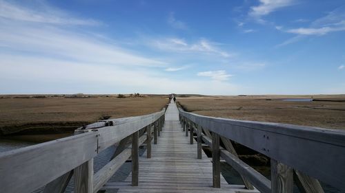 View of wooden bridge against sky