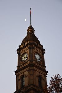 Low angle view of clock tower against sky