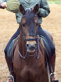 Low section of man riding horse