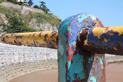 Close-up of rusty metal against blue sky