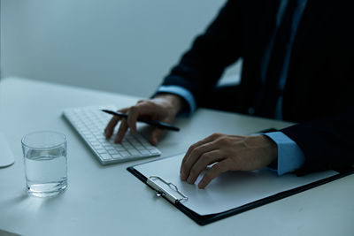 Midsection of man working on table