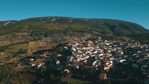 High angle view of town against clear blue sky