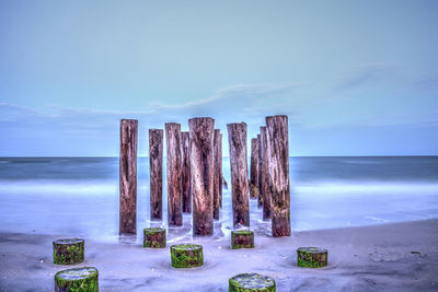 Dawn over a dilapidated pier on the beach in port royal in naples, florida.