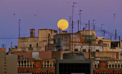 Buildings in city against clear sky