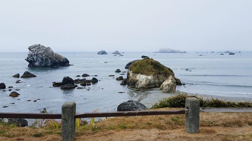 Fence with rocks in water 