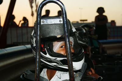 Portrait of boy in helmet while karting