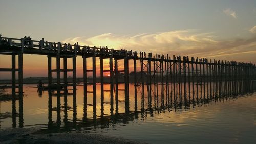 Silhouette pier on sea against sky during sunset