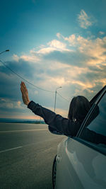 Cropped image of airplane wing against sky during sunset
