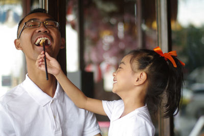 Girl feeding father