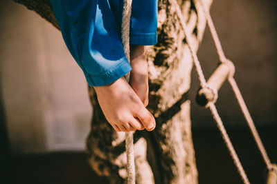 Midsection of man holding rope