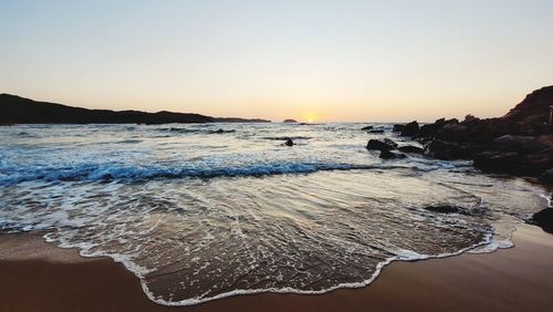 Scenic view of sea against clear sky during sunset