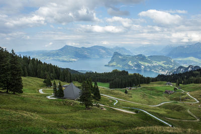 Scenic view of field and mountains against sky