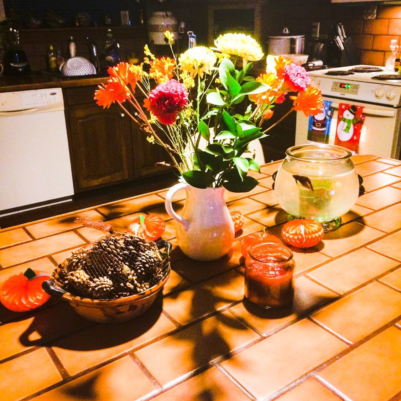 indoors, table, potted plant, food and drink, freshness, variation, flower, high angle view, decoration, vase, red, tiled floor, fruit, flooring, glass - material, flower pot, retail, food, no people, plant