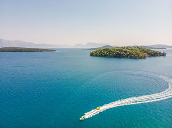 Tracking aerial shot of moving motor boat.