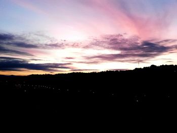 Silhouette landscape against sky during sunset