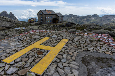 Alpine hut among the granite rocks of the lagorai mountain range with the helicopter landing pad 