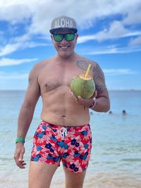 Portrait of mature hispanic man standing at beach