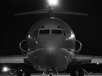 Low angle view of illuminated airplane at night