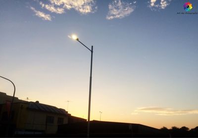 Low angle view of illuminated lights against sky during sunset