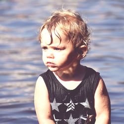 Baby boy by lake