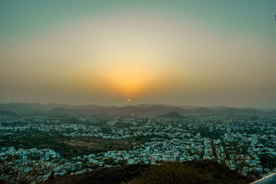 Aerial view of townscape against sky during sunset