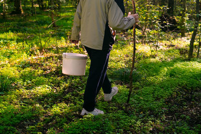Low section of woman standing on field