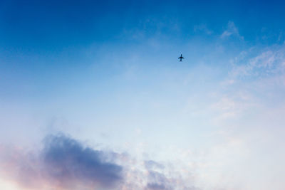 Low angle view of airplane flying in sky