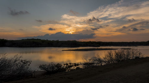 Scenic view of lake against sky during sunset