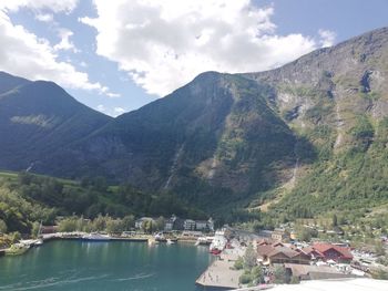 Scenic view of lake by mountains against sky