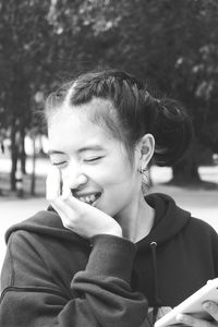 Close-up of smiling woman standing outdoors