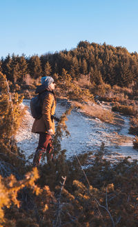 Rear view of man walking in winter