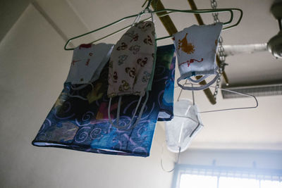 Low angle view of clothespins hanging on rope