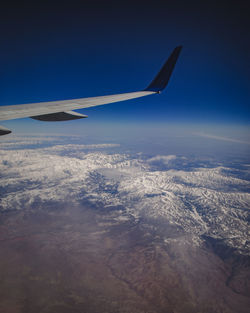 Aerial view of aircraft wing against sky