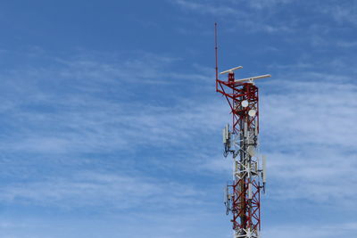 Low angle view of communications tower against sky