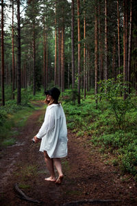 Full length of woman walking in forest