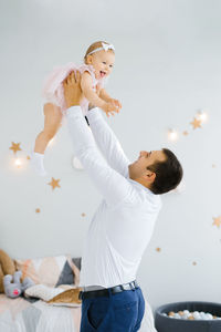 Father lifting baby girl. happy father picks up and throws his lifting a small child