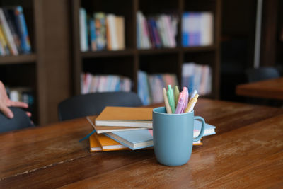 Close-up of open book on table at home