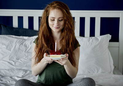 Portrait of senior woman sitting on bed