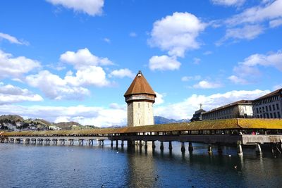 View of bridge over river against cloudy sky