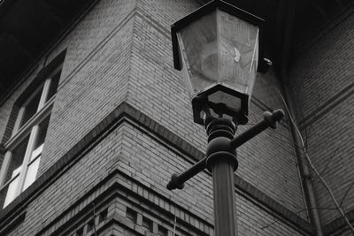 Low angle view of electric lamp on building