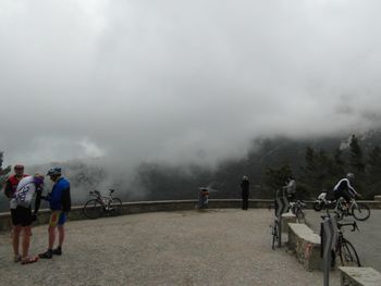 People on mountain against sky