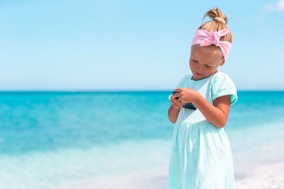 Portrait of boy standing at beach