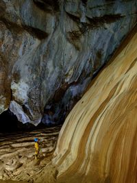 Side view of person standing in cave