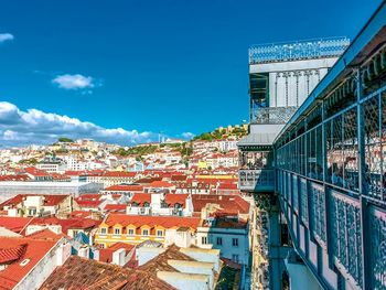 Buildings in city against blue sky